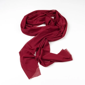 Detailed macro shot of the elegant wine red chiffon fabric with a lightweight airy texture