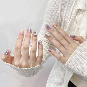 Handmade press-on nails in purple cat-eye and pink gradient with luxury rhinestones