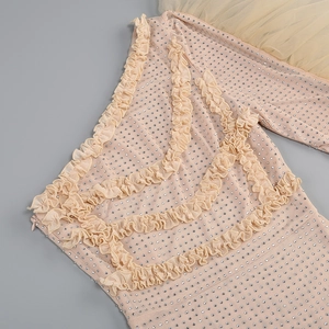 Detail of pink ruffled dress with silver rhinestones, mesh fabric, and side zipper