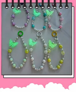 Close-up of colorful luminous butterfly beaded keychains and phone straps