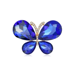 Detailed macro view of blue crystal butterfly brooch with gold plating and rhinestones