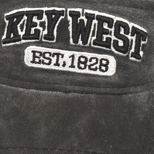 Detailed close-up of Key West 1828 embroidery on washed gray cotton sun visor cap