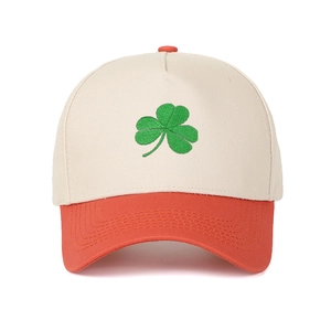 Close-up of green shamrock embroidery on a five-panel contrast trucker baseball cap