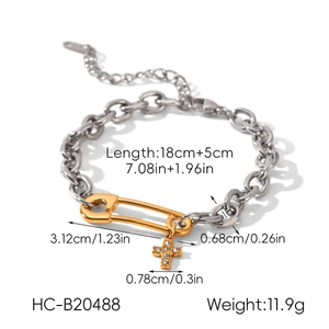 Two-tone stainless steel chain bracelet with gold safety pin and crystal cross charm