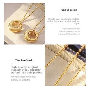 Macro detail of oval pendant necklace in 18K gold plated titanium steel chain