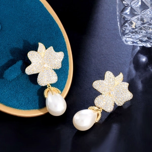 Elegant gold flower earrings with micro-pave zircons and white teardrop pearls
