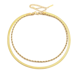 Detail of gold double layer necklace featuring flat herringbone and twisted rope chains