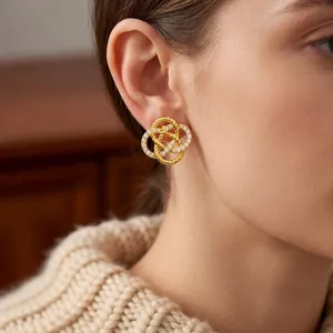 French vintage gold pleated hoop earrings with sparkling cubic zirconia on model