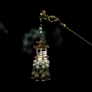 Detail of a golden Chinese hair pin featuring a lantern pendant and elegant white pearls