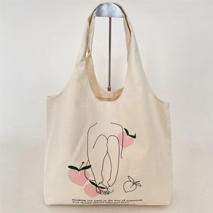 Detail of cream canvas tote bag with minimalist peach line art and inspiring quotes