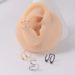 Detail view of double-layer stainless steel ear cuffs on model showing clip-on design