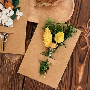 Detailed view of dried Gomphrena flower bouquet on kraft paper greeting card for gifts