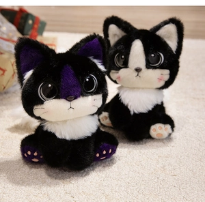 Close-up of cute black plush cat dolls with big eyes and soft microfiber texture