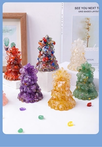 Macro shot of colorful crystal resin Christmas trees with gold foil on a desk