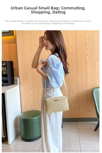 Detail showing natural straw weave texture and white leather strap of the square crossbody bag