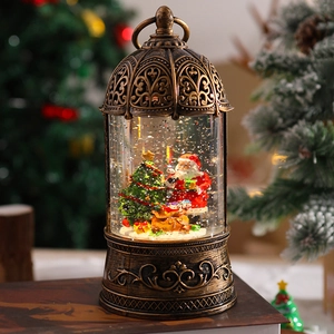 Macro detail of retro bronze Christmas snow globe lantern with Santa Claus and glitter