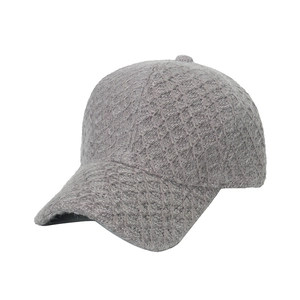 Grey knitted baseball cap with a textured diamond pattern and curved brim for casual wear