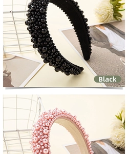 Detail of hand-sewn pearls on wide black and pink headbands with vintage style
