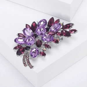 Elegant silver alloy floral brooch with purple and pink crystals on geometric stand