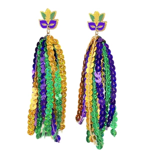 Macro shot of Mardi Gras tassel earrings featuring sequined jester masks and beads