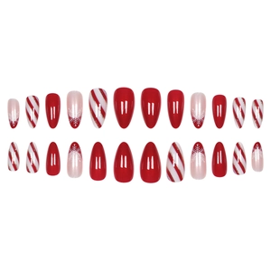 Christmas almond press-on nails with red candy cane stripes and white snowflake patterns