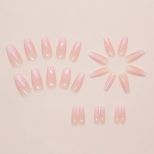 Macro view of long ballerina shape press-on nails with soft pink ombre gradient finish