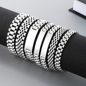 Close-up of assorted stainless steel watch-style link bracelets for men in silver finish