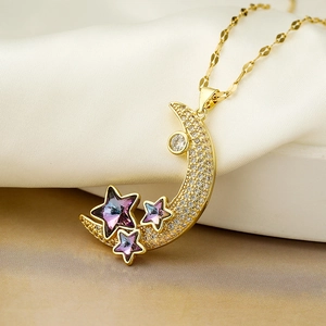 Gold star and moon necklace with purple zircons on white silk and stone surface