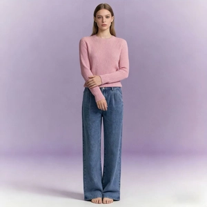 Detail of high-waist wide-leg denim jeans paired with pink striped knit sweater