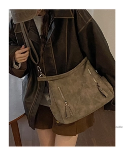Detail view of large vintage brown suede tote bag with double vertical zipper pockets