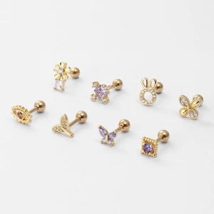 Set of eight gold floral and butterfly ear studs with purple zircon and screw back