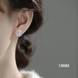 Iridescent white pearl stud earrings 14mm round spheres on female model