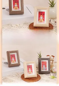 Close-up of minimalist wooden frames with Chinese inspirational cards on a warm desk setup