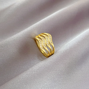 Adjustable four-layer gold-plated wave ring with zircon pave on elegant silk background