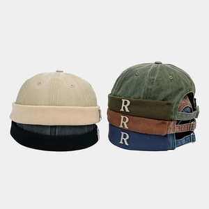 Detail of cotton miki hats featuring vintage metal R logo and adjustable metal buckle strap