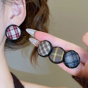 Detail showing vintage plaid fabric button earrings in various autumn color patterns