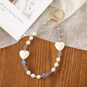Detail of beaded phone strap with iridescent heart charms and gold lobster clasp