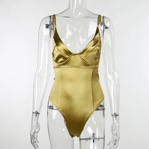Close-up detail of golden satin bodysuit featuring thin straps and smooth silk texture
