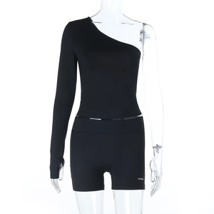 Detail of black one-shoulder long sleeve top and slim fit shorts set on a mannequin