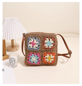 Detail of bohemian crochet square bag with colorful grandmother squares and leather strap