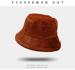 Detailed view of dark brown plush fisherman hat with thick faux fur texture and warm fabric