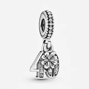 Macro view of silver number 40 pendant with clover element and inlaid cubic zirconia