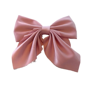 Pink satin bow hair clip for women with elegant silk texture and minimalist design