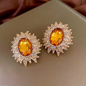 Gros plan de boucles d'oreilles tournesol vintage avec gemme ambre et strass brillants
