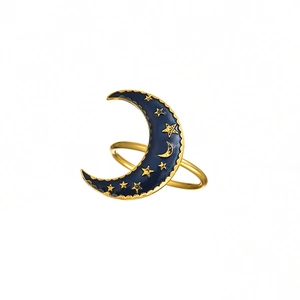Macro shot of blue crescent moon napkin ring with gold stars on white background