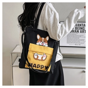 Close-up of black canvas tote with yellow pocket featuring a cute Corgi and HAPPY text