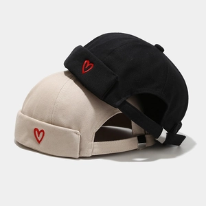 Minimalist cotton brimless docker caps in black and beige with red heart embroidery