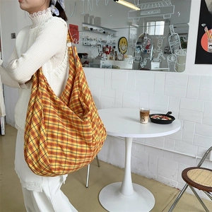 Detail of checkered hobo bag with large capacity and metallic ring connection detail