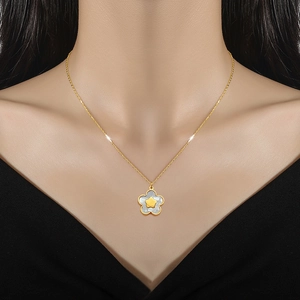 Minimalist gold titanium necklace featuring a white shell flower pendant with a star center