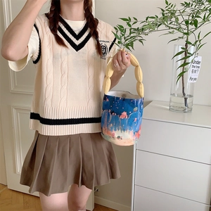 Artistic canvas bucket bag with cute blue cartoon print and yellow padded handle